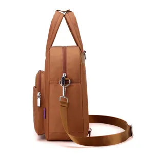 Side detail view of brown nylon backpack with top handle, quilted pocket and straps.