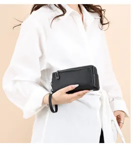 Compact black genuine leather women's clutch bag with wrist strap, ideal for phone and cash.