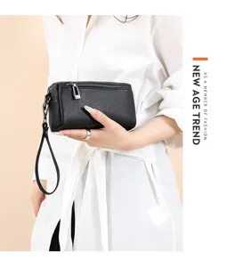 Black leather clutch bag detail shot, compact design with wrist strap for women mobile phone.