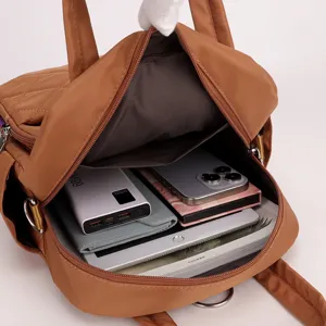 Detailed interior view of brown quilted nylon backpack showcasing large capacity and compartments.