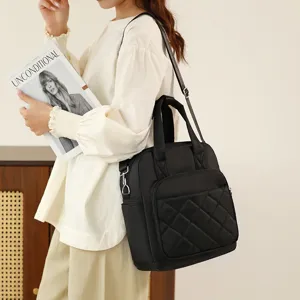 Black nylon quilted backpack for women, convertible shoulder bag with top handle.