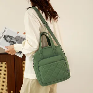 Green nylon quilted backpack detail, casual shoulder bag with dual straps and pocket.