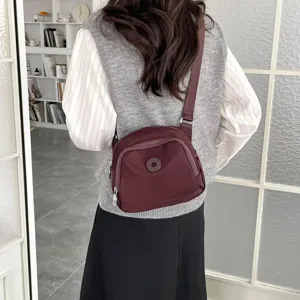 Casual nylon crossbody bag, lightweight shell shoulder bag for daily commute and travel style.