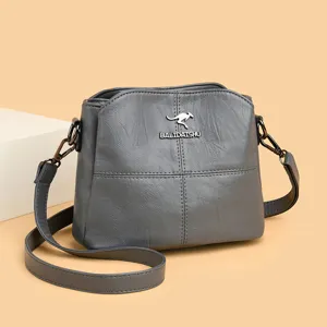 Grey leather shoulder bag for women, stylish crossbody handbag with adjustable strap.