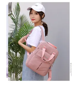 Stylish pink casual backpack for women, large capacity travel and school laptop bag.
