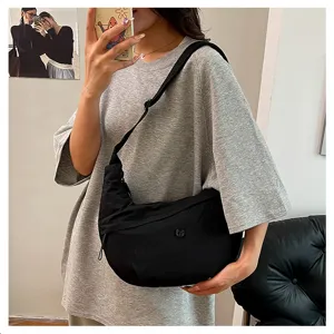 Detailed view of casual black nylon crescent shoulder bag, perfect for daily crossbody wear.