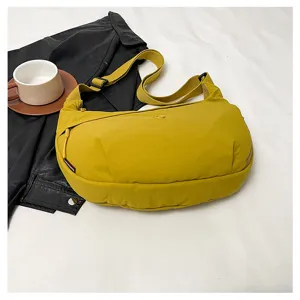 Detail view of the yellow nylon crescent shoulder bag, casual lightweight crossbody style.