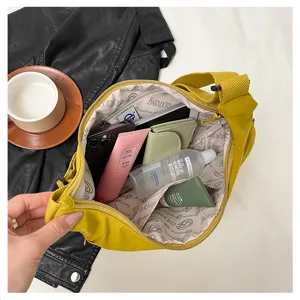 Detail view of large capacity waterproof nylon crossbody bag, showing interior storage space.