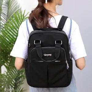 Casual black backpack detail, multi-pocket design, daily travel, comfortable straps.