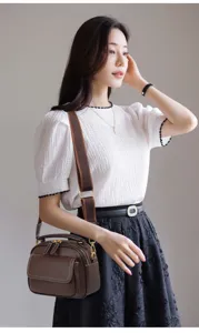 Stylish brown multi-layer crossbody bag showcasing detailed craftsmanship and elegant design.