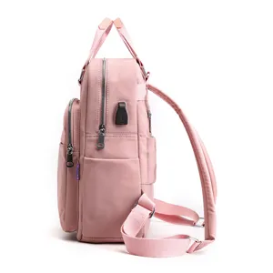 Casual pink backpack for women with USB charging port, large capacity school bookbag.