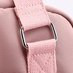 Detailed shot of the pink casual backpack strap and metal buckle, durable and stylish.