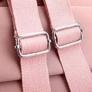 Close-up detail of the pink backpack adjustable strap with durable metal buckle hardware.