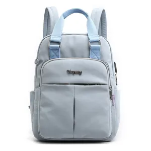 Casual women's blue backpack with USB charging port, large capacity travel school bag.