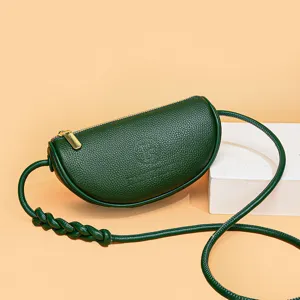 Dark green leather crescent crossbody bag with stylish braided strap and zipper.