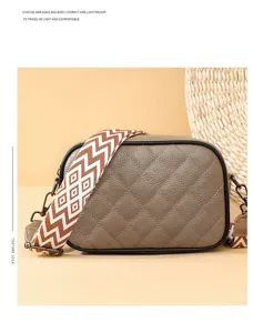 Stylish leather crossbody bag with quilted design and wide patterned strap for daily wear.