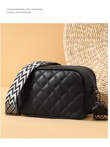 Black leather quilted crossbody bag with stylish geometric wide strap for women daily wear.