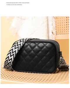 Detailed view of black quilted leather crossbody bag with chic geometric wide shoulder strap.