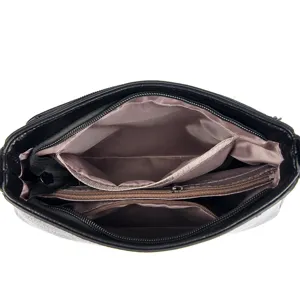 Women handbag interior lining detail multi compartment zipper pocket black design