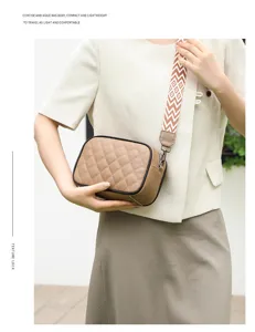 Genuine leather quilted crossbody bag with wide patterned strap, compact stylish shoulder bag.
