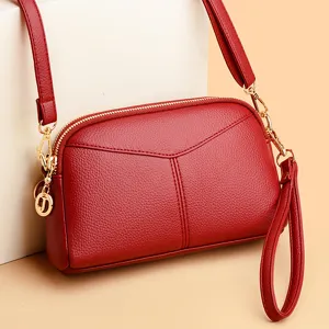 Stylish red PU leather women shoulder bag crossbody handbag with soft surface and zipper pockets.