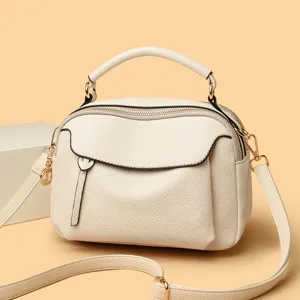 Trendy stylish beige leather crossbody bag with top handle and spacious interior daily use.
