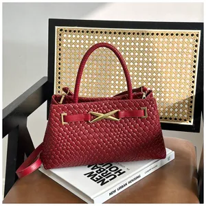 Stylish dark red woven leather handbag with metal buckle, versatile crossbody and shoulder bag.
