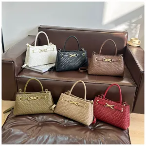 Woven top handle shoulder handbags in various colors featuring metal clasp and strap.