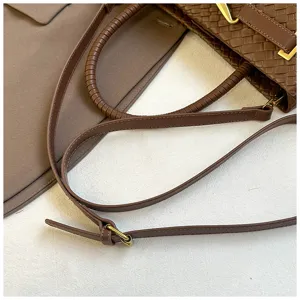Close-up detail of stylish brown woven leather women handbag with metallic hardware.