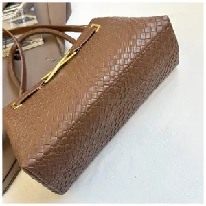 Minimalist brown woven shoulder bag for women, stylish top-handle handbag with metal hardware.