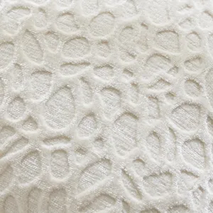 Close-up of soft chenille fabric cushion cover with textured embossed pattern detail.