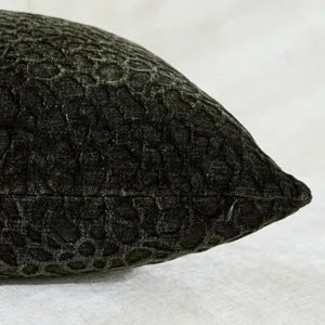 Dark green chenille textured pillow cover detail, soft solid cushion case with plum pattern.