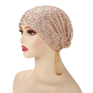 Detailed view of beaded mesh turban cap with golden tassel, elegant design and elastic fit.