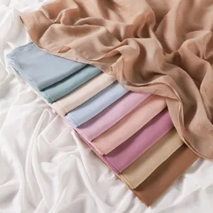 Close-up detail of solid color shimmer chiffon hijab scarf with fine pleats and silver threads.