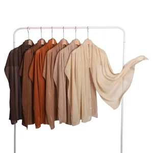 Detailed view of lightweight silver silk chiffon scarves in earth tones hanging neatly.