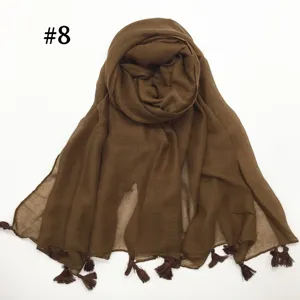 Detailed view of the soft brown voile scarf with delicate tassels, showcasing the breathable texture.