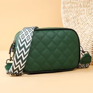 Green quilted leather crossbody bag with wide patterned strap, stylish women's shoulder bag.