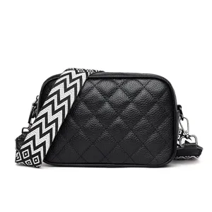 Black quilted leather crossbody bag with chic wide geometric strap for women daily casual wear.