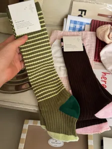 Detailed view of women's vintage striped long socks, soft combed cotton, cozy fashion style.