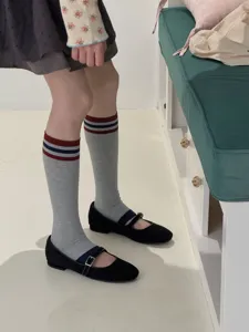 Detailed close-up of retro gray striped long socks with classic color block design, comfortable fabric.