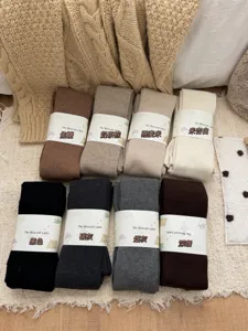 Detailed view of winter woolen thermal tights, ribbed solid color hosiery in multiple shades.
