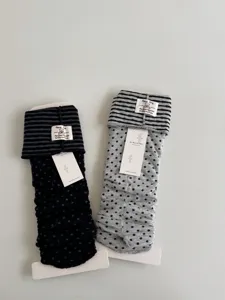 Korean vintage style knit stirrup leg warmers featuring contrast stripes and dots.