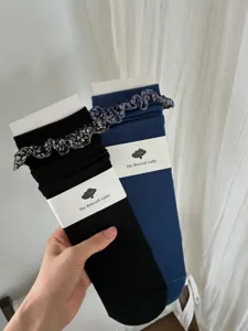 Korean style floral ruffle mid-tube slouch socks in black and blue for daily casual wear.