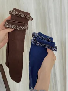 Details view of Korean style ruffled mid-calf socks with floral lace trim for autumn wear.