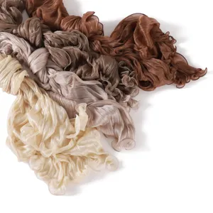 Detailed shot of lightweight pleated sheer long scarf with delicate lettuce edge design.