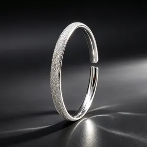 Elegant silver-tone frosted open bangle bracelet featuring a sparkling stardust textured finish.