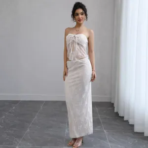 Elegant white lace strapless top and matching maxi skirt two-piece set for women.