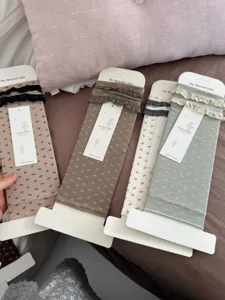 Cozy floral stirrup socks with delicate lace trim, comfortable vintage style leg warmers for women.