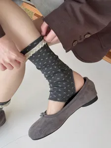 Detailed view of womens floral lace stirrup socks in grey, cozy and sweet style for autumn.