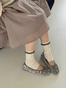 Detail shot of sweet floral print socks featuring delicate lace trim for cozy autumn styling.